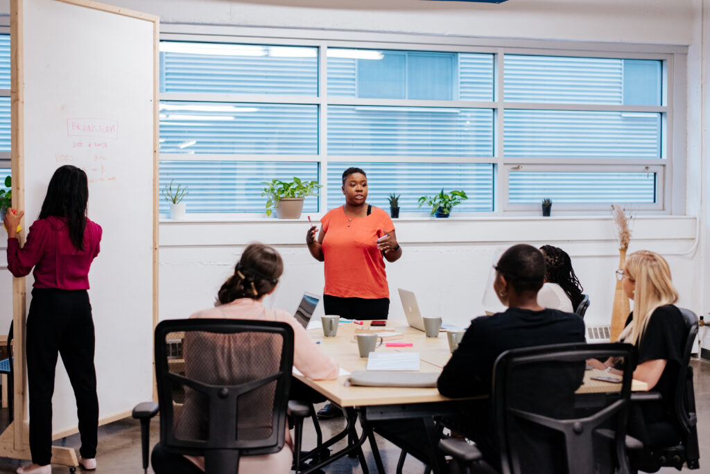 Business coach meeting with entrepreneur and providing strategic guidance during a coaching session